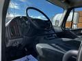 Interior view of a 2016 Freightliner M2 106 cab showing the steering wheel dashboard and driver's seat