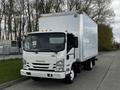 A 2022 Isuzu NPR truck with a large white cargo box and a front cab featuring a prominent grille and headlights