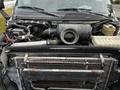 A 2006 GMC C5000 engine bay showcasing various components including the air intake system an oil reservoir and a radiator with visible piping and wiring