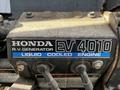 A close-up of a Honda EV4010 generator with a liquid cooled engine label attached to the unit