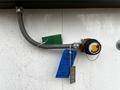 A Huntair Custom Air Handler Unit with an attached flexible hose and a valve featuring a chain and tag labeled do not remove