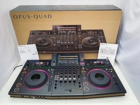 A Pioneer OPUS-QUAD DJ controller with two large jog wheels and multiple buttons and sliders for mixing and effects management