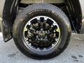 A close-up of a black alloy wheel with a silver Toyota emblem, showcasing a Michelin tire with a rugged tread pattern