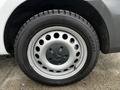 A silver wheel with circular holes featuring a Mercedes-Benz emblem in the center mounted on a black tire marked with the name Hestaker