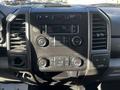 Dashboard of a 2018 Ford F-550 featuring buttons for audio control climate settings and a digital display