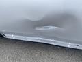 A silver 2006 Land Rover LR3 with a noticeable dent and scratch on the side panel