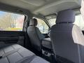 Interior view of a 2024 Ford F-550 showing front seats and a center console with fabric upholstery
