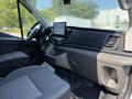 Interior view of a 2022 Ford Transit showcasing the dashboard with a central touchscreen display and seating area
