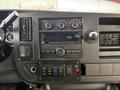 Dashboard of a 2019 Chevrolet Express featuring a radio control panel air conditioning knobs and various button controls
