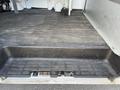 A 2014 Chevrolet Express cargo van with an open rear loading area showing a flat rubberized floor and step for easy access