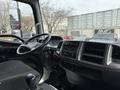 Interior view of a 2017 Hino 338 cab with a steering wheel control panel and gear shift visible