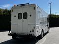 2009 Morgan Olson Workhorse vehicle with a closed rear, featuring two openings with mesh screens and an amber light on top