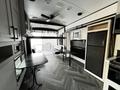 Interior of a 2022 Heartland Torque featuring a table, kitchen area with a refrigerator, and spacious layout with a modern design