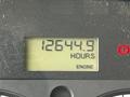 Display panel showing 12644.9 hours on a 2010 Freightliner M2 106 engine with a red warning light indicator