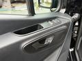 Close-up of the door panel of a 2022 Mercedes-Benz Sprinter showing the window controls and textured interior material