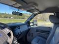 Interior of a 2016 Ford F-250 SD showing the dashboard and driver's seat with gray upholstery and a steering wheel