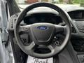 Steering wheel of a 2016 Ford Transit Connect with a Ford logo and various controls visible