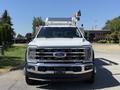 A 2024 Ford F-550 Super Duty truck with a chrome grille and distinctive headlights displayed head-on