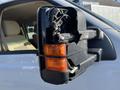 Close-up of a damaged side mirror on a 2014 Ford F-350 SD showing broken parts and exposed wiring