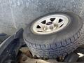 A close-up of a wheel and tire from a 2014 GMC Sierra 1500 showing the rim design and tread pattern of the tire