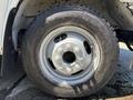 A close-up of a silver wheel with a rugged tire labeled Ranger mounted on a 2020 Chevrolet Express