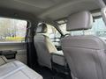 Interior view of a 2020 Ford F-550 showing the front seats and dashboard with light beige upholstery and a spacious cabin design
