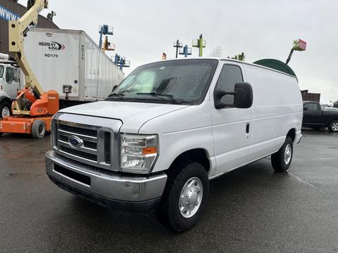 A 2011 Ford Econoline van in white with a silver grille and wheels parked with its side facing the viewer