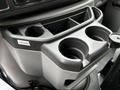 Cupholder console of a 2013 Ford Econoline featuring two cupholders and a small storage compartment