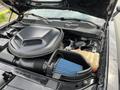 Close-up of the engine compartment of a 2017 Dodge Challenger highlighting the air intake and fluid reservoir