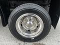 A chrome wheel rim mounted on a black tire designed for a 2019 Ford F-550