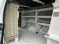 Interior of a 2009 Ford Econoline van showing empty shelving and storage compartments without any cargo