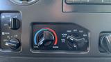 Climate control panel from a 2013 Ford Econoline featuring knobs for temperature adjustment and air circulation settings