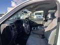 Interior view of a 2018 GMC Sierra 1500 with gray fabric seats and a central console visible in the foreground