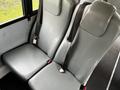 Two gray seating units with seatbelts designed for a bus interior