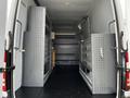 The interior of a 2017 Mercedes-Benz Sprinter with gray shelving units and drawers designed for storage and organization