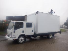 A white 2019 Isuzu NQR truck with a large box cargo area is shown at an angle with its cab visible and the rear of the truck extending out of the frame