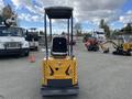 A yellow 2024 AGT Mini Excavator is displayed with an open cab and control panel visible at the front