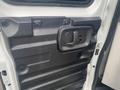 Interior side of a 2012 Chevrolet Express door with a textured surface and a door handle in the center