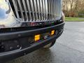 A 2015 International 3000 front bumper featuring chrome grilles and amber warning lights mounted on the lower section