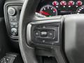 Steering wheel controls of a 2021 Chevrolet Silverado 3500HD showing buttons for cruise control and settings