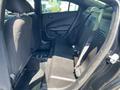 Interior view of the back seat of a 2019 Dodge Charger showing two seats with fabric upholstery and a seatbelt on the right side