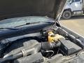 A 2014 Ford F-150 with the hood raised displaying the engine compartment and various components including hoses and a coolant reservoir