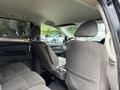Interior view of a 2014 Honda Odyssey showing the back seats and center console with cup holders