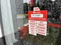 A 2020 Chevrolet Express with a red certificate of approval sticker displayed on a window detailing monthly inspection dates for 2026