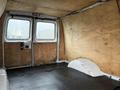 Interior view of a 2008 Ford Econoline van showing a bare floor with wooden paneling on the walls and no seats or additional furnishings