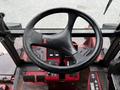 The steering wheel of a 2012 Toro Groundsmaster with a red dashboard and control panels visible in the foreground