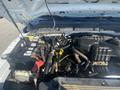 Engine compartment of a 2014 Ford F-250 SD showing the engine components battery and wiring