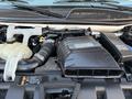 Engine compartment of a 2015 GMC Savana showcasing the Duramax Diesel engine and surrounding components