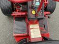 A red 2017 Ferris Rotary mower with controls and warning labels visible on the dashboard and foot pedals