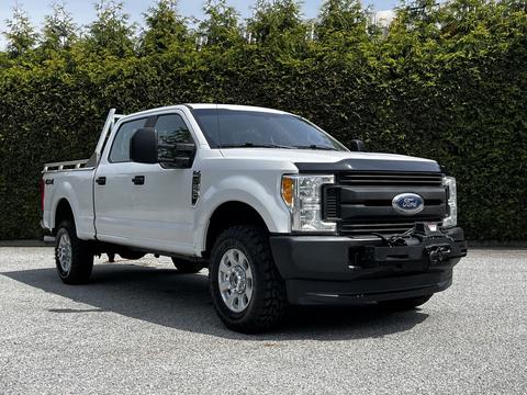 A 2017 Ford F-250 SD is shown with a white exterior and chrome accents featuring a four-door crew cab and off-road tires